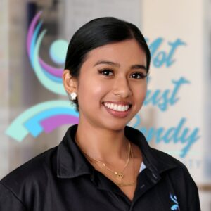 Aanavi, a dark skinned west Asian woman with tied up black hair.